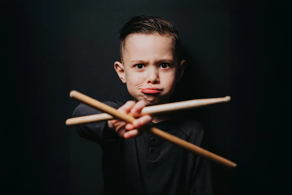 Young drummer holding drumsticks