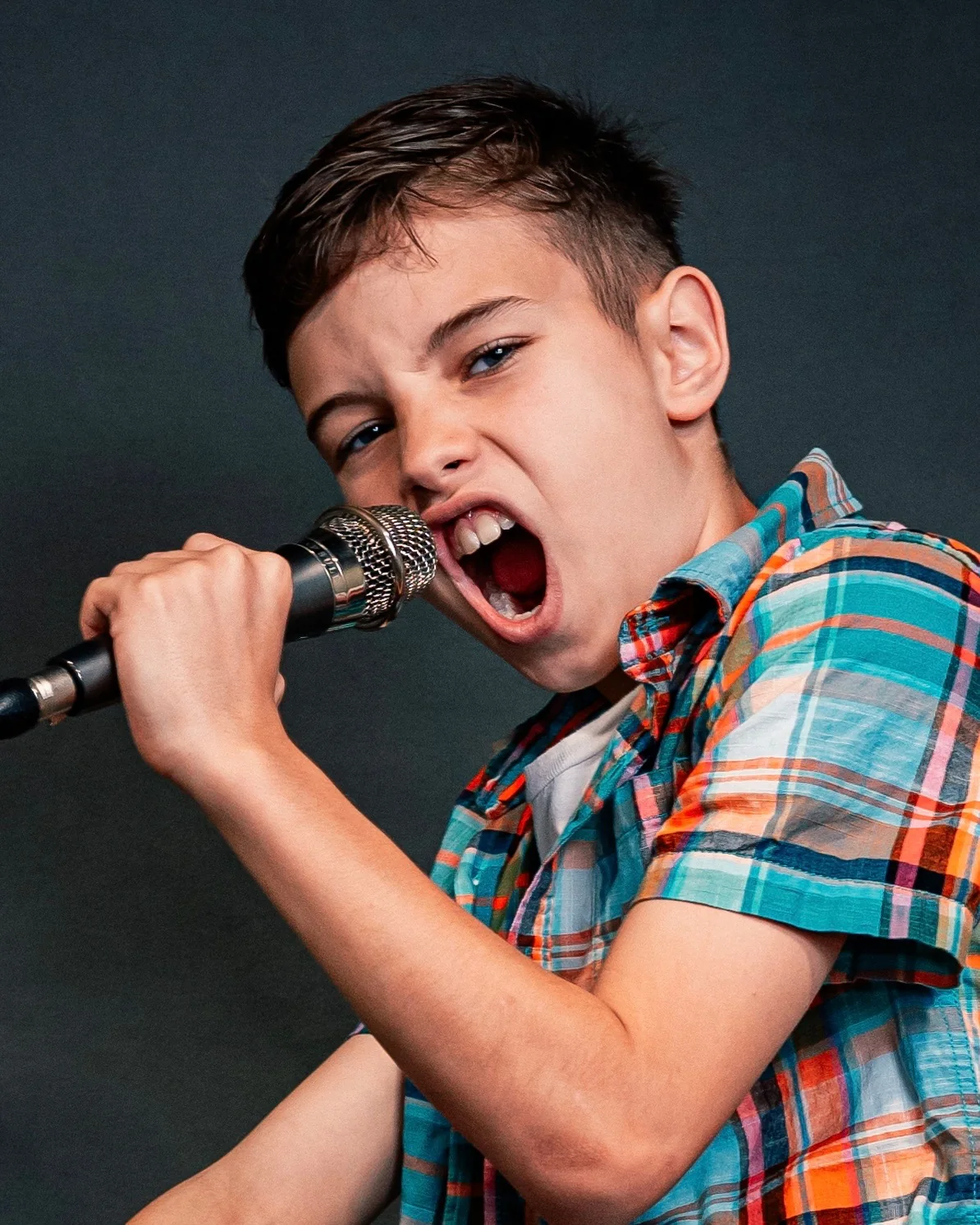 Young vocalist performing into a microphone